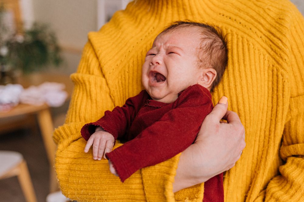 Nouveau-né réconforté dans les bras d'un parent